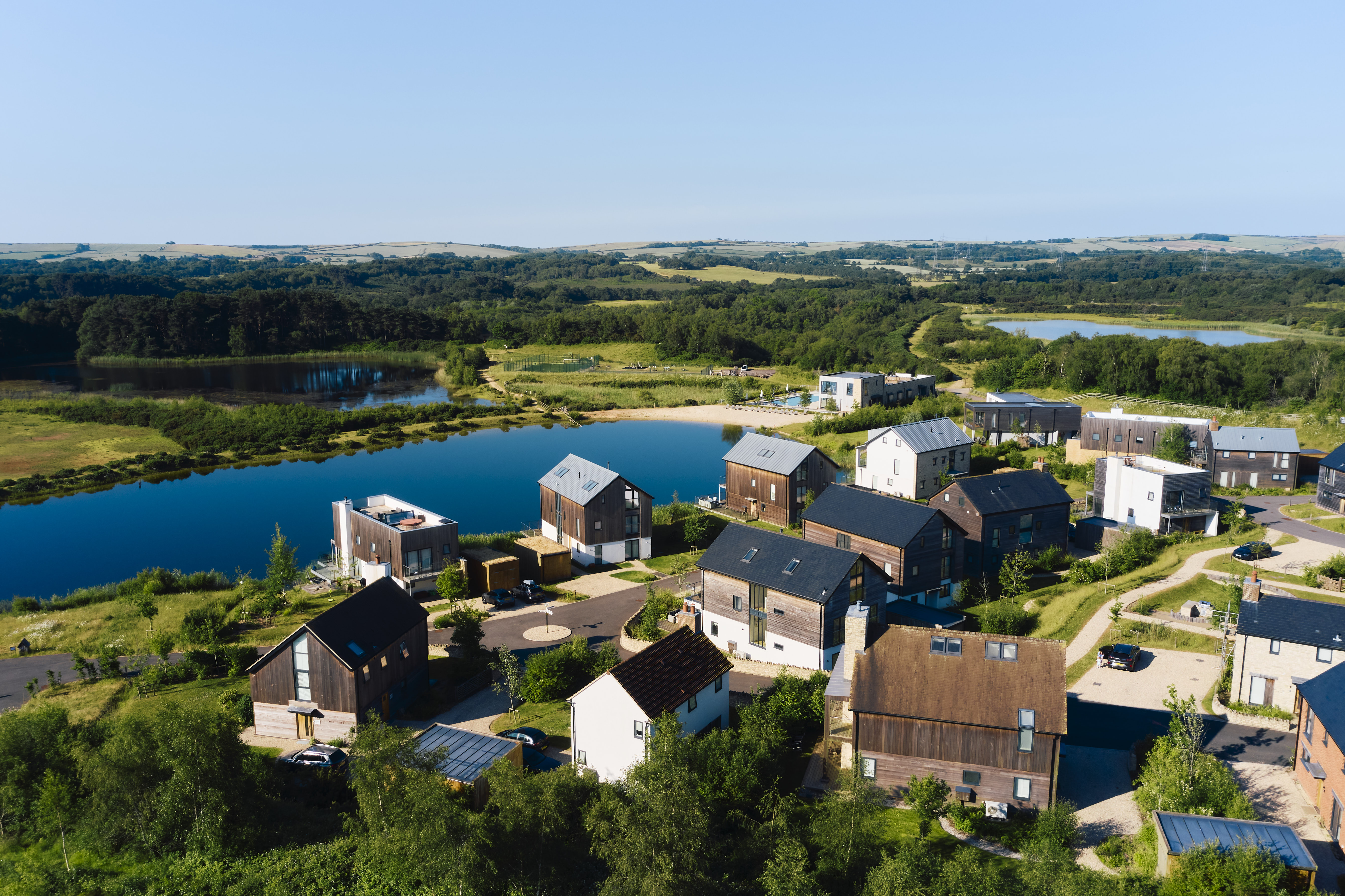 An aerial view of holiday homes next to a lake